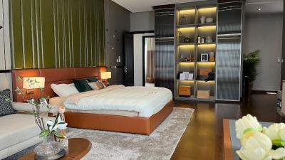 Modern bedroom with a large bed, built-in closets, and stylish decor