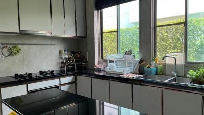 Modern kitchen with ample natural light and black countertops