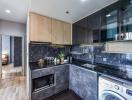 Modern kitchen with black marble countertops and wooden cabinets