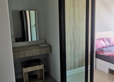Modern bedroom with large mirror and en-suite entrance