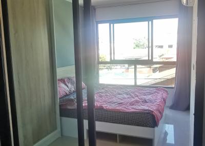 Modern bedroom with large window and sliding door