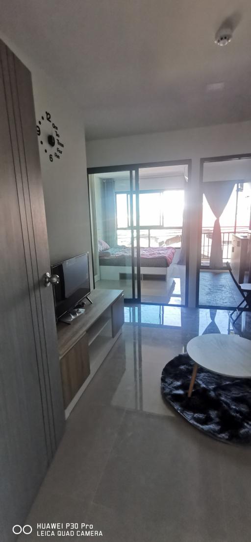 Modern living room with natural light and balcony access