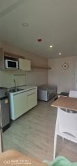 Compact studio apartment with kitchenette, bed, and dining area