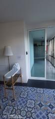 Cozy bedroom with decorative floor tiles and sliding door leading to the bathroom