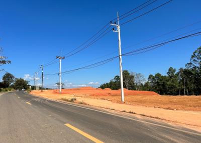 paved road next to a construction site under a clear blue sky