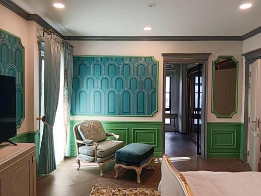 Elegant bedroom with green paneled walls and classic furniture