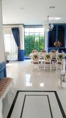 Elegant dining room with white furniture and blue accent walls