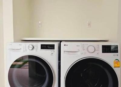 A modern laundry room featuring an LG washer and dryer