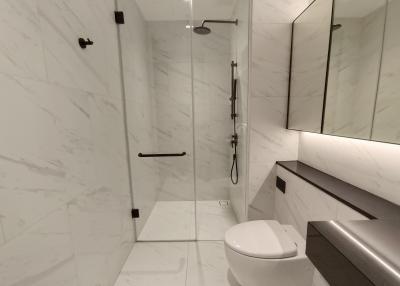 Modern bathroom with marble tiles and walk-in shower
