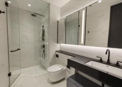 Modern bathroom interior with glass shower and large mirror