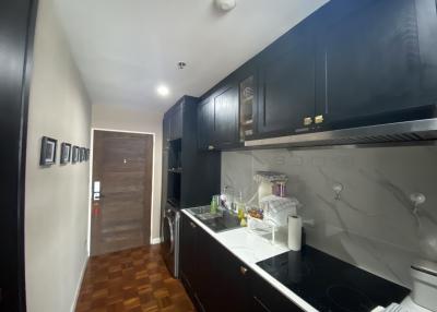 Modern kitchen with dark wood cabinets and stainless steel appliances