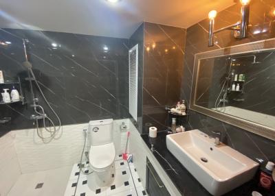 Modern bathroom with black marble tiles and sleek fixtures