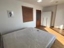 Cozy bedroom with natural light and hardwood floors