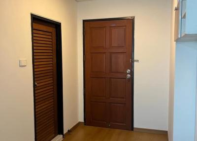 Wooden flooring and brown doors at the property entrance