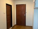 Wooden flooring and brown doors at the property entrance