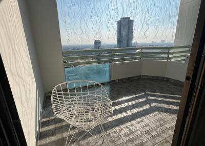 Sunny balcony with modern wire chair and city view