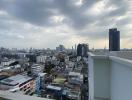 Panoramic city view from high-rise apartment balcony