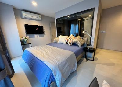 Cozy bedroom with queen-sized bed and modern furnishings