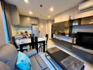 Modern apartment living space with open plan layout including kitchen, dining, and living area