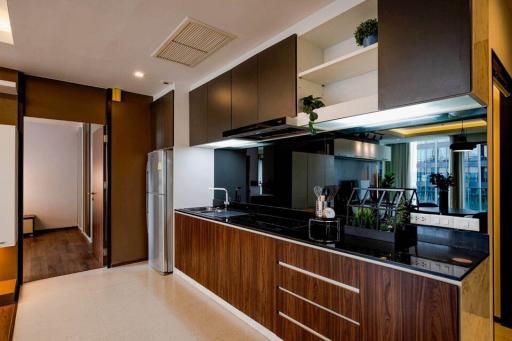 Modern kitchen with wooden cabinets and stainless steel appliances