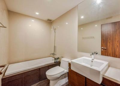 Modern bathroom with tub, toilet, and sink