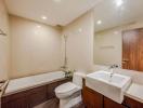 Modern bathroom with tub, toilet, and sink