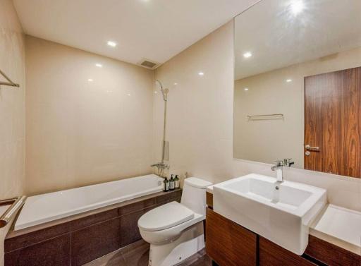 Modern bathroom with tub, toilet, and sink