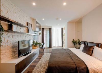 Modern bedroom with stone accent wall and expansive window