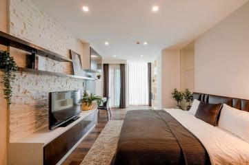 Modern bedroom with stone accent wall and expansive window