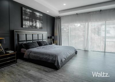 Contemporary bedroom with large windows and stylish decor
