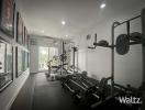 Home gym with exercise equipment and framed pictures