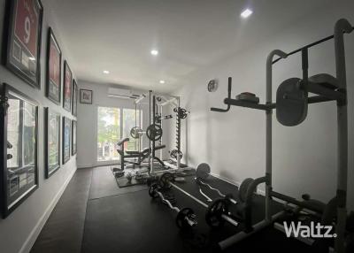 Home gym with exercise equipment and framed pictures
