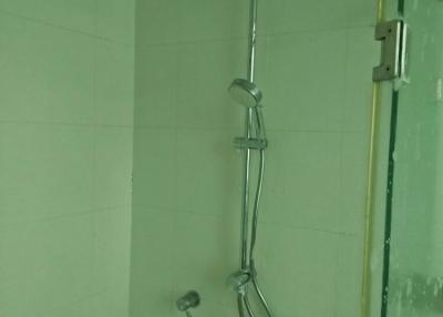 Modern shower with versatile shower head in a tiled bathroom.