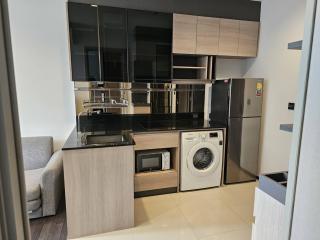 Modern kitchen with built-in appliances and laundry area