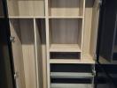 Modern empty wooden wardrobe with open doors and shelves