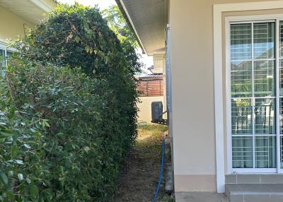 Side yard with air conditioning unit and garden hose