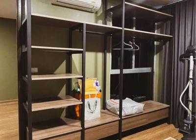 Compact bedroom with modern shelving unit and workout equipment