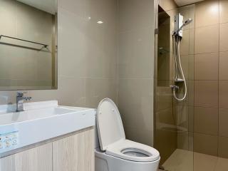 Modern bathroom with beige tiles and white fixtures