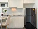 Modern kitchen with stainless steel appliances and white cabinetry