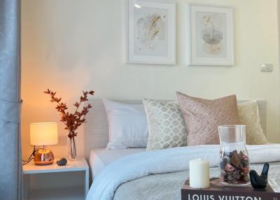 Cozy bedroom with decorative pillows and artwork