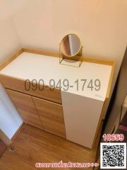 Modern wooden bedroom dresser with a circular mirror and parquet flooring