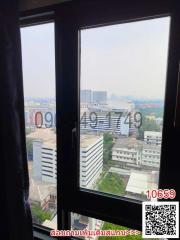 View from a high-rise building window overlooking the city