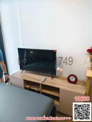 Modern bedroom with a flat-screen TV on a wooden console