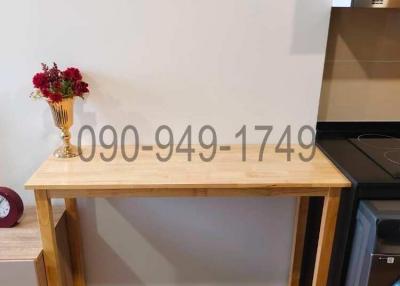Modern kitchen interior with wooden table and flowers on top