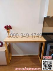 Modern kitchen interior with wooden table and flowers on top