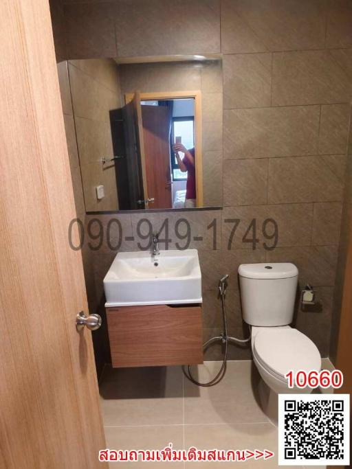 Modern bathroom with sink, toilet, and mirror