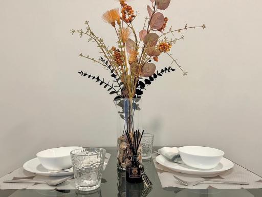 Elegantly set dining table with decorative flowers