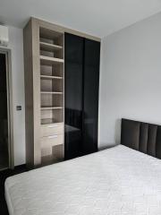 Modern bedroom with large bed and built-in wardrobe