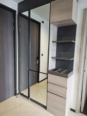 Modern entryway with wooden finishes and built-in shoe storage