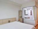 Bright bedroom with attached bathroom and built-in wardrobes